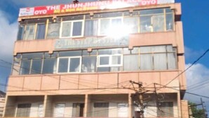 A multi-story building with a sign for 'The Jhunjhunu Palace' and 'Oyo' on the top floor. - Oyo  The Jhunjhunu Palace Hotel (Jhunjhunu)