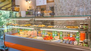 A breakfast buffet with various food items and beverages. - Agriturismo 'Il Nazareno - Civetta' with Shared Pool, Private Terrace and Wi-Fi (Cecina)
