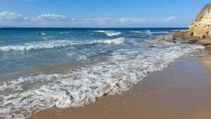 A beach with clear blue water, waves, and a rocky shoreline. - Family villa Keshi - not far from Tsilivi beach (Tragaki)