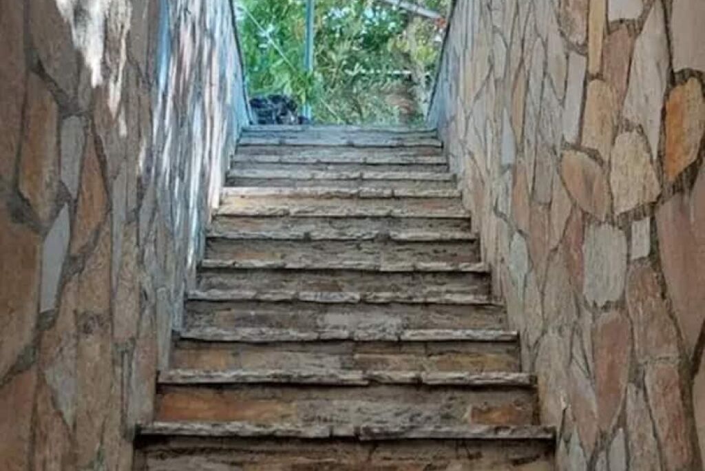 A stone staircase leading upwards, surrounded by stone walls.