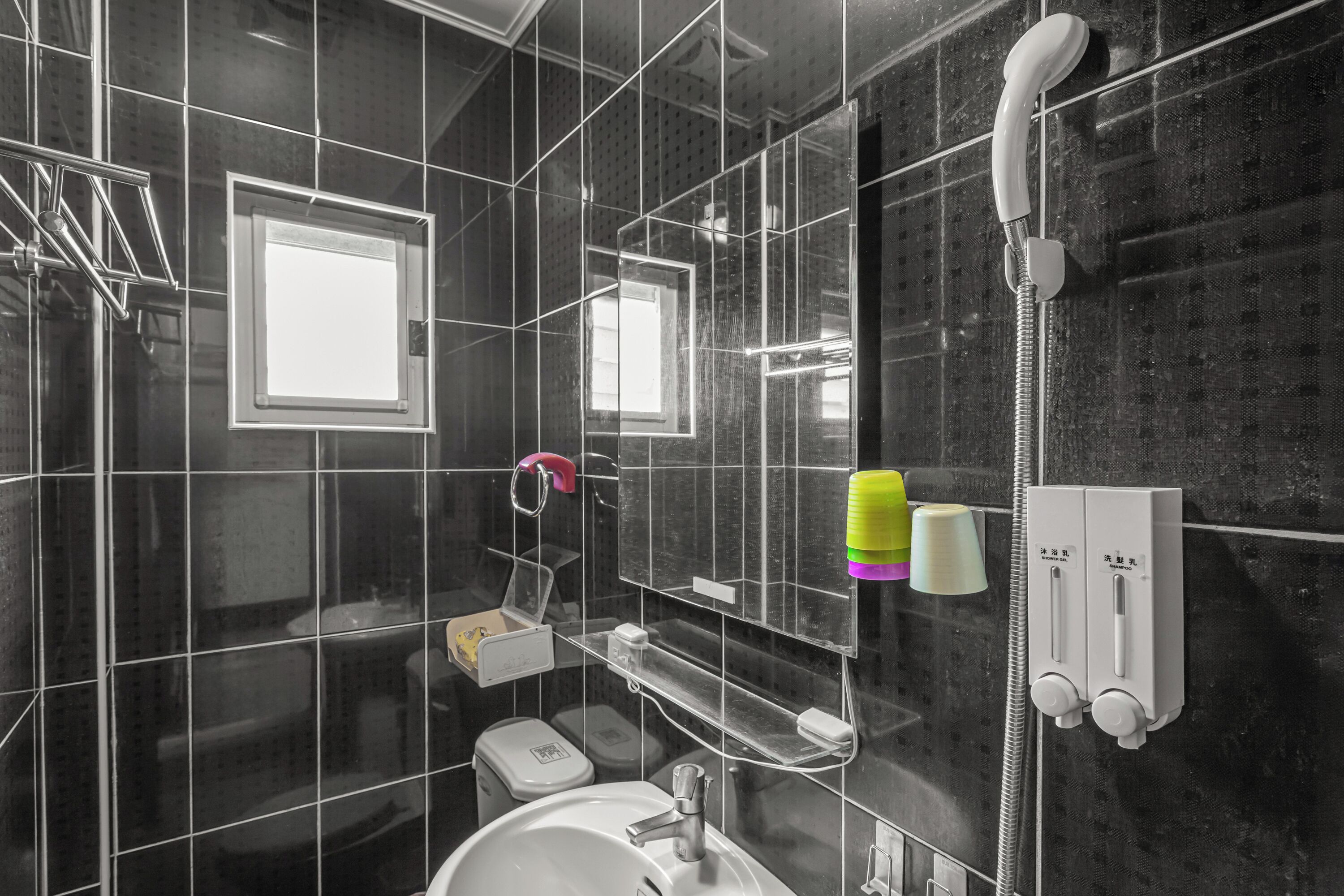A modern bathroom with a glass-enclosed shower, a sink, and a toilet.