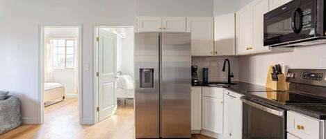 Fridge, microwave, coffee/tea maker, cookware/dishes/utensils