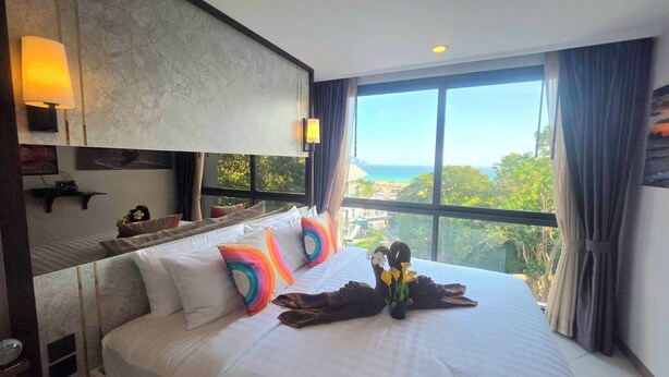 A hotel room with a large bed, a view of the ocean, and a modern design. - Room-a304 - 1 Bedroom Condo With Sea Vie (Krabi)