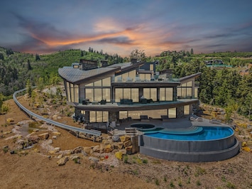 The iconic mansion featured in HBO's Mountainhead film, with views of the mountains of Deer Valley in the background