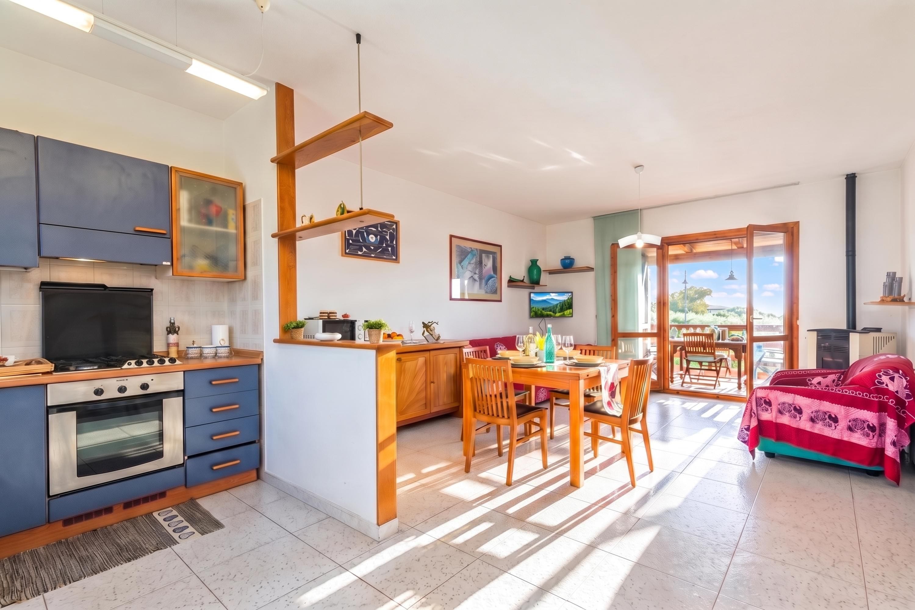 A modern kitchen with a dining area, featuring a stove, oven, and wooden cabinets.