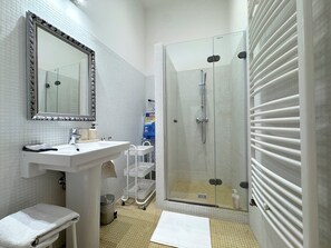 Shower, hair dryer, slippers, towels