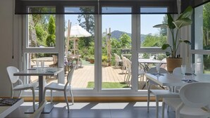 A modern room with large sliding glass doors leading to an outdoor patio area. - Txanka Erreka (Orio)