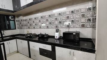 Fridge, microwave, cookware/dishes/utensils, dining tables