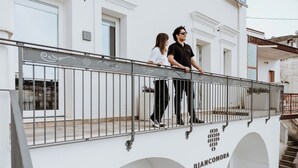 Un bâtiment à la façade blanche, doté d’un balcon avec des balustrades en métal, et sur lequel on peut lire l’inscription « Biancomora ».