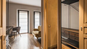 A modern apartment with a wooden floor, a desk, two chairs, a wardrobe, and a staircase. - Licia (Rome)