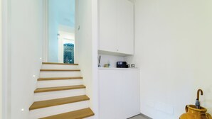 A staircase with wooden steps leading to a white door.