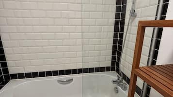 Combined shower/bathtub, deep-soaking bathtub, hair dryer, towels
