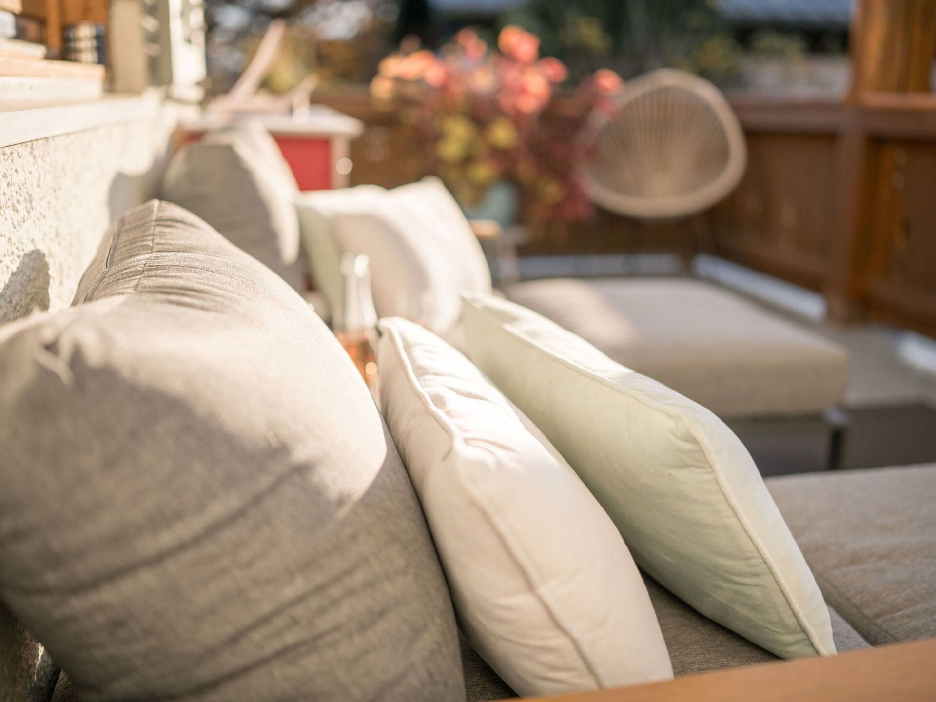A sofa with multiple cushions in a well-lit room.