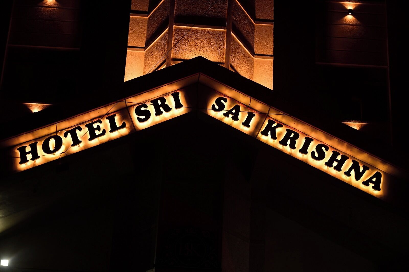 A hotel sign with the name "HOTEL SRI SAI KRISHNA".
