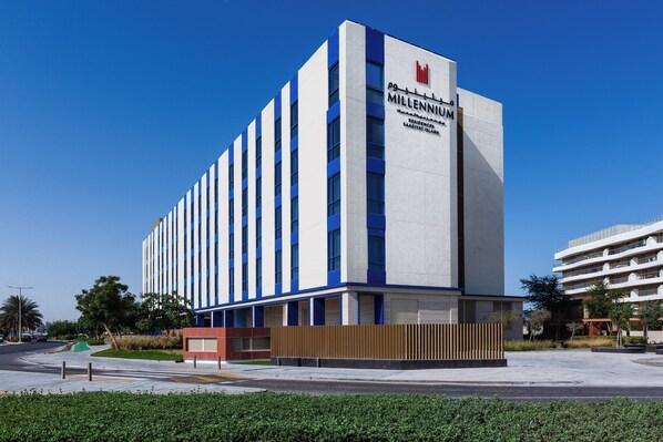 A modern hotel building with a prominent sign reading "Millennium Residences." - Millennium Residences Saadiyat Island (Abu Dhabi)