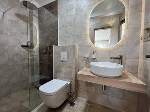 Een douche, een haardroger, een bidet, handdoeken