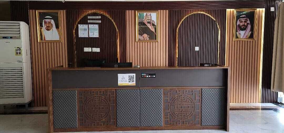 Una recepción con cuadros enmarcados, una pantalla digital y un fondo decorado.