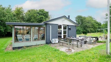 A small, single-story building with a covered patio area.