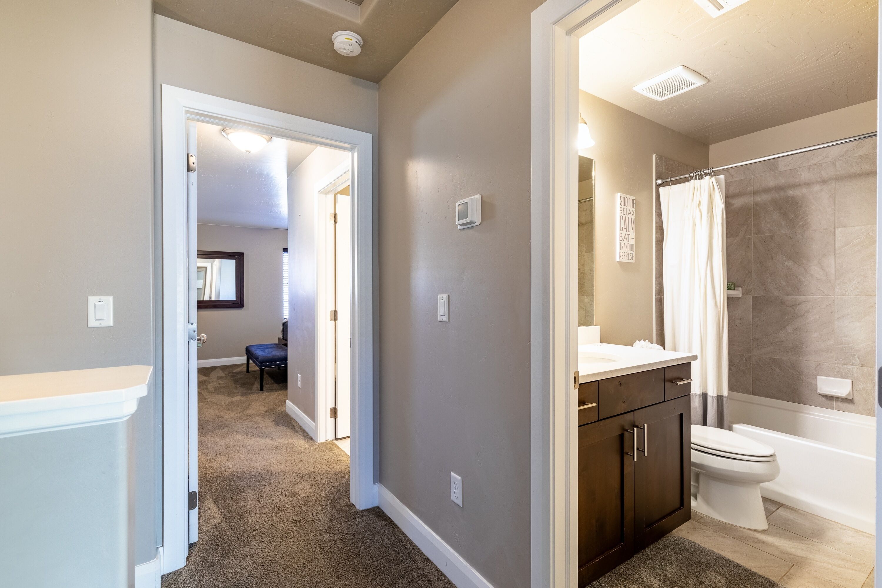 A bathroom with a shower, toilet, and vanity.