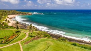 A golf course with a view of the ocean and beach. - Kauai Poipu Sands 222 2 Bedroom Condo (Koloa)