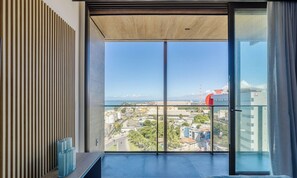 A balcony with a view of a coastal cityscape, including a port and industrial buildings. - Nwts - Studios With Side sea View in Maceio III (Maceió)