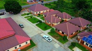 A residential area with multiple houses featuring red roofs and brick exteriors. - BowMarie Resort (Kpandai)
