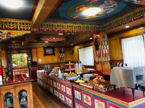 A buffet area with a variety of food items and a coffee station. - Kathmandu View Hotel (Kathmandu)