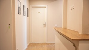 A hallway with a wooden floor, a door labeled '101', and a wooden counter on the right. - C&P Luxury Guest House Rome (Rome)
