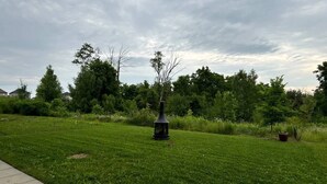 A grassy area with a pathway and a lamppost. - The Simple Escape (Kitchener)