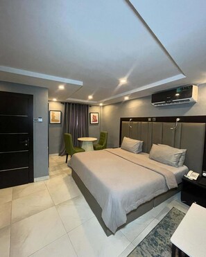Deluxe Room, Balcony, City View | Desk, laptop workspace, blackout drapes, soundproofing