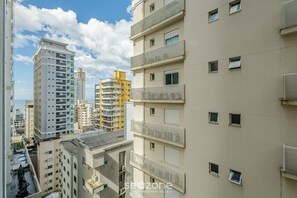 A multi-story residential building with balconies and a clear sky. - IFT - Ed. Infinity Tower Flat 350m From Meia Praia (Itapema)