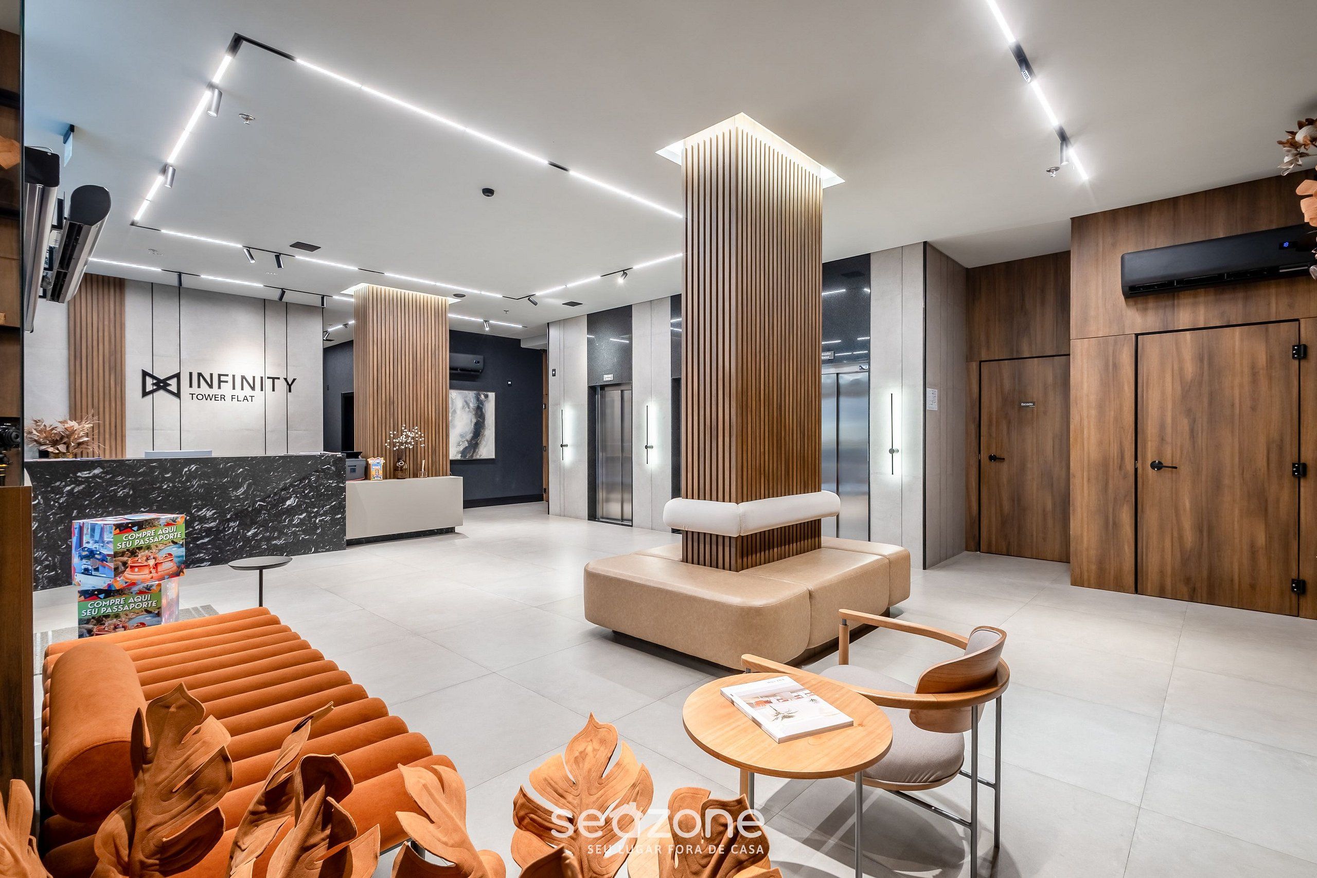A modern hotel lobby with a reception desk, seating area, and wooden accents.