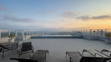 Outdoor pool, open 7:00 AM to 10:00 PM, pool umbrellas