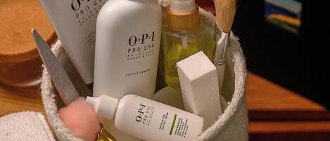 A basket containing various skincare products, including bottles and a brush.