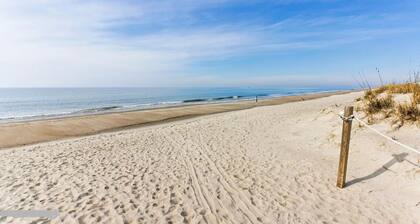 Condo steps to beach, with pool. Dog friendly!