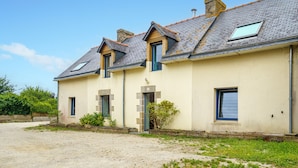 A row of three-story houses with pitched roofs and dormer windows.