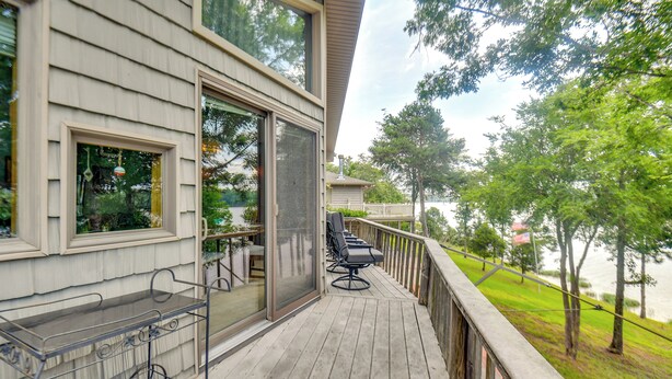 A deck with outdoor furniture, a metal cart, and a glass door leading to a covered area. - Boat Dock Access: Clarks Hill Lake Hideaway! (Elberton)
