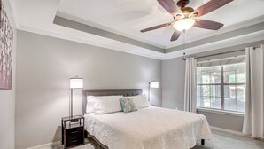A bedroom with a bed, nightstands, a ceiling fan, and a window with curtains. - Updated Retreat w/ Outdoor Space in Flowood! (Flowood)