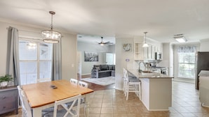 A spacious kitchen with white cabinetry, a wooden dining table, and a large island. - Updated Retreat w/ Outdoor Space in Flowood! (Flowood)