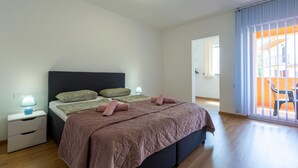 A bedroom with a bed, nightstands, and a view of an outdoor area. - Awesome apartment in Umag with WiFi (Umag)