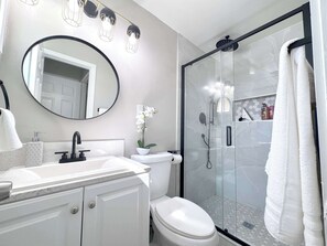 Shower, hair dryer, towels, shampoo