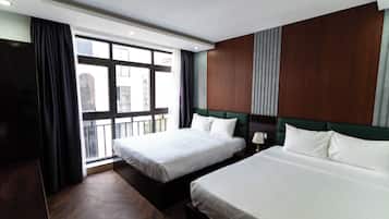 Deluxe Triple Room, City View | Desk, laptop workspace, blackout drapes, soundproofing