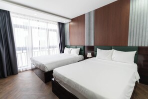 Deluxe Triple Room, City View | Desk, laptop workspace, blackout drapes, soundproofing