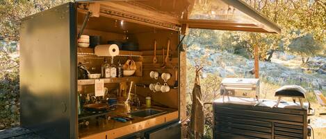 Fridge, coffee/tea maker, cookware/dishes/utensils, dining tables