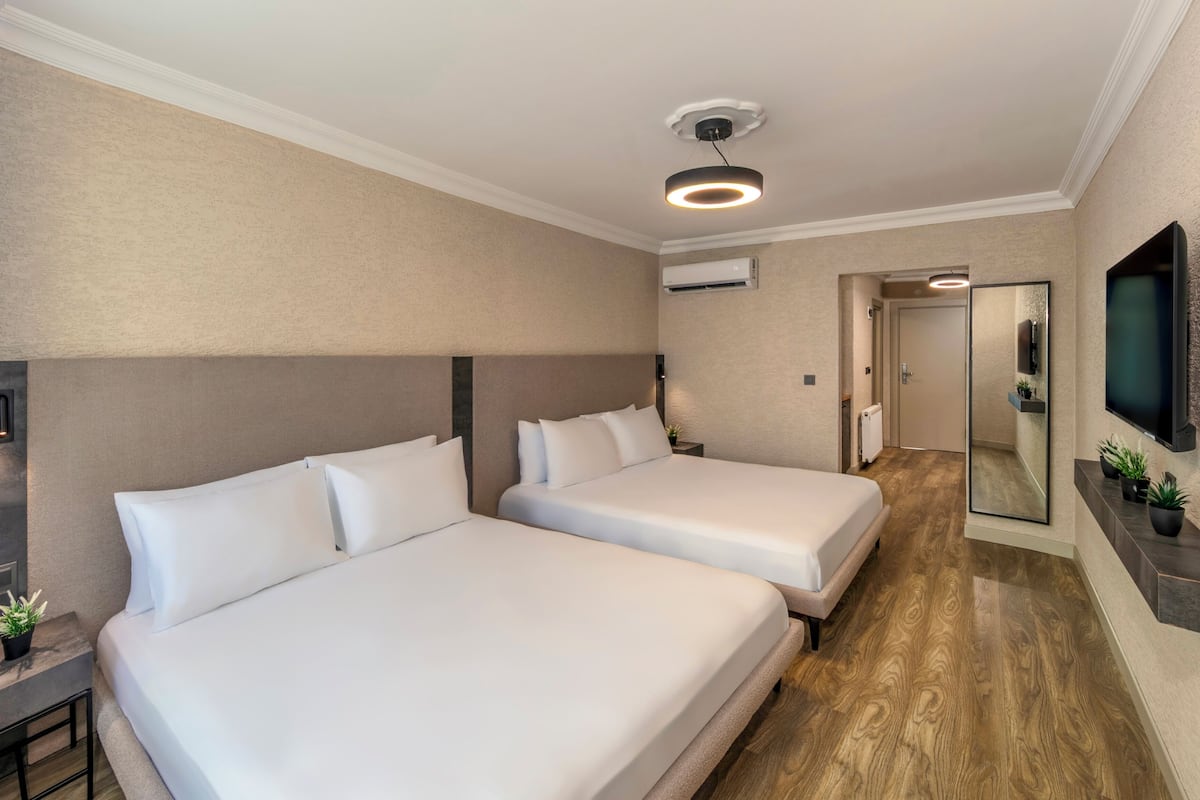 Deluxe Quadruple Room | Premium bedding, in-room safe, desk, laptop workspace