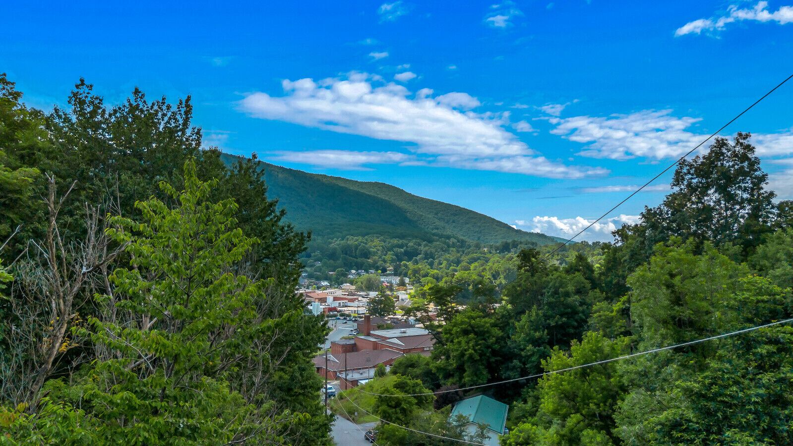 Eine Stadt eingebettet in ein Tal mit einer Bergkulisse.