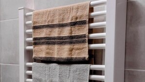 A towel warmer with three towels in different patterns.