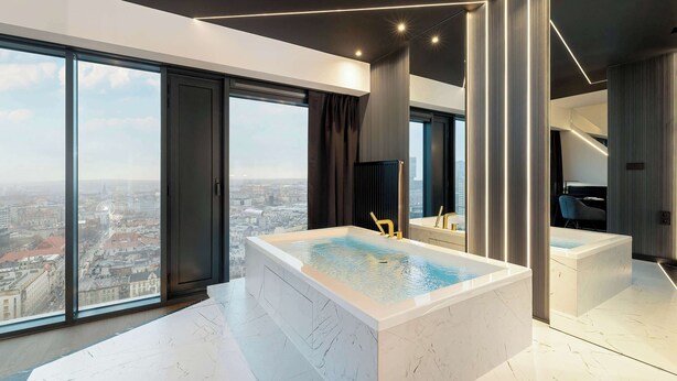 A modern bathroom with a large bathtub, a view of the city, and a sleek design. - Unique Studio with a View | Parking | Jacuzzi (Katowice)