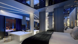 A modern bedroom with a large bed, a separate bathroom, and a city view. - Unique Studio with a View | Parking | Jacuzzi (Katowice)