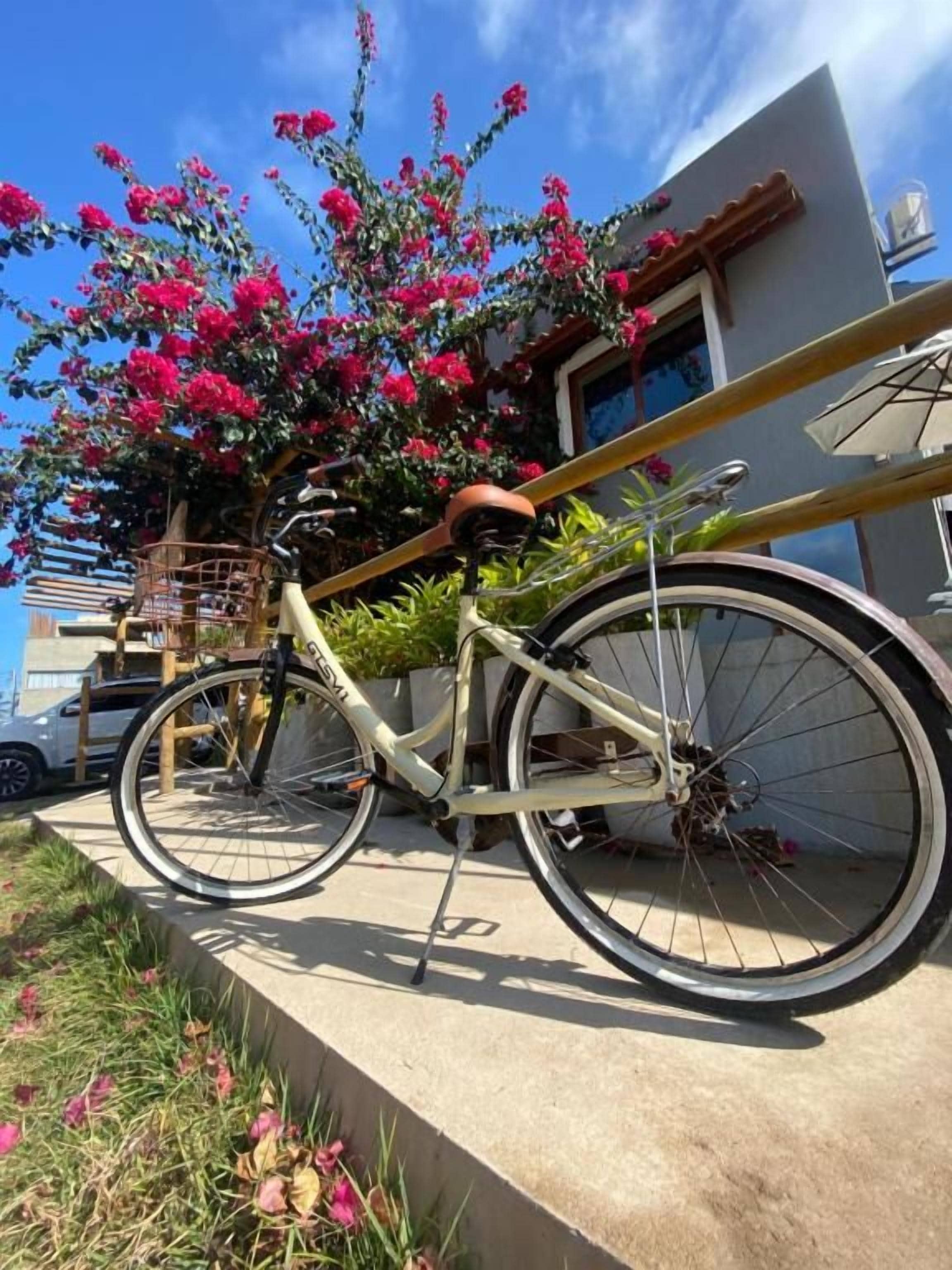 A bicycle parked on a concrete ledge with a building in the background.